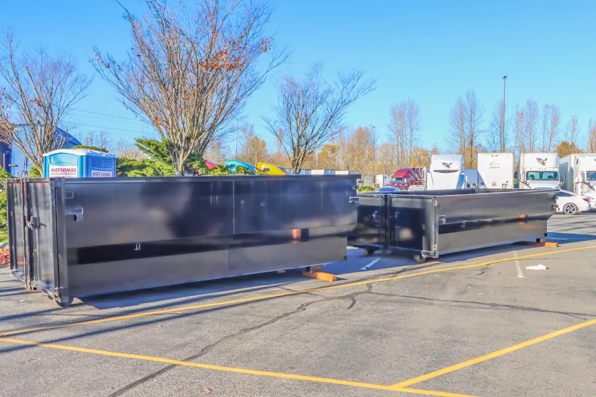 Professional dumpster rental service with roll-off container on residential driveway in Anthony